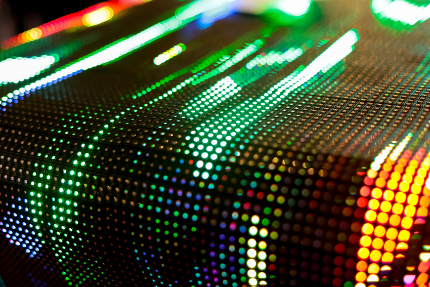 A close up array of LEDs, showing multiple colors in shades of green. It is a grid pattern of LEDs, as you would find on an LED Digital Display or LED Video Wall.